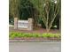 Entrance to the Creswick Condominiums featuring lush landscaping and a stone sign at 2545 Stockbridge Dr, Charlotte, NC 28210