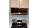 Modern stainless steel microwave and range hood complete this kitchen's updated design at 2545 Stockbridge Dr, Charlotte, NC 28210