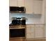 Stainless steel appliances and modern white cabinetry accent this home's contemporary kitchen at 2545 Stockbridge Dr, Charlotte, NC 28210