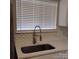 Kitchen sink with stainless steel faucet, designer backsplash, and updated counters at 2545 Stockbridge Dr, Charlotte, NC 28210