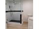 Glass shower enclosure with tile accent, rainfall shower head, and handheld sprayer at 2545 Stockbridge Dr, Charlotte, NC 28210