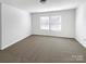 This is a carpeted bedroom with a neutral palette and a large window at 2609 Riley Woods Ln, Charlotte, NC 28269