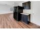 An efficient kitchen area features black appliances, granite countertops and wood flooring at 2609 Riley Woods Ln, Charlotte, NC 28269