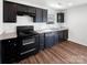 This well-lit kitchen features dark cabinets, stainless steel appliances, and granite countertops at 2609 Riley Woods Ln, Charlotte, NC 28269