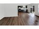 Bright living room features an open floor plan, wood floors, and plenty of natural light from kitchen at 2609 Riley Woods Ln, Charlotte, NC 28269