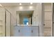 Bathroom featuring a double sink vanity with modern fixtures and a large mirror at 299 Berrybeth Cir, China Grove, NC 28023