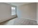 Bedroom with neutral walls and carpeting featuring a window and bright natural light at 299 Berrybeth Cir, China Grove, NC 28023