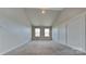 Large bedroom with vaulted ceilings, paneled accent wall, and plush carpeting at 299 Berrybeth Cir, China Grove, NC 28023