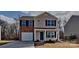 Charming two-story home with a brick accent, covered porch, and well-maintained landscaping at 299 Berrybeth Cir, China Grove, NC 28023