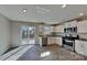 Well-lit kitchen boasting stainless steel appliances, granite counters, and sliding glass doors to the backyard at 299 Berrybeth Cir, China Grove, NC 28023