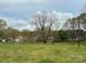 Expansive backyard with a large tree offering shade and a peaceful setting at 3342 York Hwy, Gastonia, NC 28052
