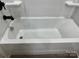 Clean white bathtub with matte black faucet in a bright and modern bathroom setting at 3342 York Hwy, Gastonia, NC 28052