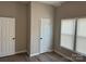 Bedroom featuring wood-look floors, windows, and white doors and trim, offering a simple and comfortable space at 3342 York Hwy, Gastonia, NC 28052