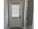 A bright white front entry door with a window and blinds and passage to another room at 3342 York Hwy, Gastonia, NC 28052