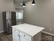 Stylish kitchen featuring stainless steel appliances, white cabinetry, a quartz island, and modern pendant lights at 3342 York Hwy, Gastonia, NC 28052
