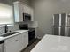 Updated kitchen with white cabinets, stainless steel appliances, quartz countertops, and modern backsplash tiles at 3342 York Hwy, Gastonia, NC 28052