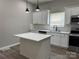 Open concept kitchen with white cabinetry, stainless appliances, quartz counters, and a convenient center island at 3342 York Hwy, Gastonia, NC 28052