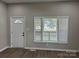Comfortable living room with a white door and windows, creating a welcoming space at 3342 York Hwy, Gastonia, NC 28052