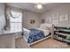 Cozy bedroom featuring a white bed frame, carpet flooring, and natural light from the window at 4107 Balsam St, Indian Trail, NC 28079
