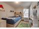 A cozy bedroom with a unique headboard, colorful rug, and built in shelves at 4107 Balsam St, Indian Trail, NC 28079