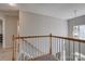 Upstairs hallway with railing and light fixture at 4107 Balsam St, Indian Trail, NC 28079