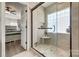 Bathroom featuring a glass shower, tile walls and wood floors at 4107 Balsam St, Indian Trail, NC 28079