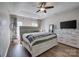 Spacious main bedroom featuring a ceiling fan, dresser, and wood floors at 4107 Balsam St, Indian Trail, NC 28079