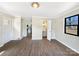 Bedroom featuring hardwood floors, neutral walls, and a bathroom with a pedestal sink at 414 N Wylie St, Lancaster, SC 29720