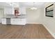 Kitchen and dining space featuring white cabinets, neutral walls and wood look floors at 414 N Wylie St, Lancaster, SC 29720