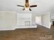 Bright living room featuring a brick fireplace, ceiling fan and light colored walls at 414 N Wylie St, Lancaster, SC 29720
