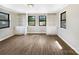 Open living room with hardwood floors, built in shelving, and natural light from the multiple windows at 414 N Wylie St, Lancaster, SC 29720