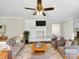 Bright living room featuring a brick fireplace, ceiling fan and neutral decor at 414 N Wylie St, Lancaster, SC 29720