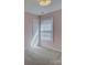 Bright bedroom featuring neutral carpet, window with blinds, and a white door at 439 Berwick Dr, Rock Hill, SC 29730