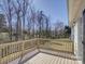 Spacious wooden deck with a railing overlooks the lawn and mature trees in the backyard at 439 Berwick Dr, Rock Hill, SC 29730