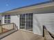 Exterior shot of sliding glass door leading onto a wooden deck with white vinyl siding at 439 Berwick Dr, Rock Hill, SC 29730