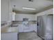 Bright kitchen features white cabinets, stainless steel refrigerator, and modern countertops at 439 Berwick Dr, Rock Hill, SC 29730
