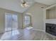 Bright living room featuring a fireplace, vaulted ceilings, ceiling fan and modern flooring at 439 Berwick Dr, Rock Hill, SC 29730