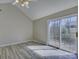 Bright living room featuring vaulted ceilings, sliding glass doors leading to the back porch, and modern flooring at 439 Berwick Dr, Rock Hill, SC 29730