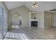 Bright living room featuring a fireplace, dining area, vaulted ceilings, and modern flooring at 439 Berwick Dr, Rock Hill, SC 29730