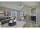 Bright living room featuring a fireplace, sliding glass doors, ceiling fan and modern flooring at 439 Berwick Dr, Rock Hill, SC 29730