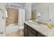 Bathroom with granite countertop, tub with shower, and neutral tile at 4624 Pebble Run Dr, Matthews, NC 28105