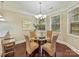 Bright dining area with hardwood floors, chandelier, and large windows at 4624 Pebble Run Dr, Matthews, NC 28105
