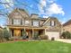 Beautiful brick home with manicured lawn and two car garage at 4624 Pebble Run Dr, Matthews, NC 28105