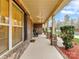 Relaxing front porch area with rocking chairs, brick and column supports, with manicured lawn at 4624 Pebble Run Dr, Matthews, NC 28105