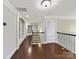 Upstairs hallway with hardwood floors, and iron railing, with access to multiple rooms at 4624 Pebble Run Dr, Matthews, NC 28105