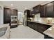 Modern kitchen with stainless steel appliances, granite countertops, and dark wood cabinets at 4624 Pebble Run Dr, Matthews, NC 28105
