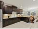 Stylish kitchen featuring dark wood cabinetry, granite counters, tile backsplash, and stainless steel appliances at 4624 Pebble Run Dr, Matthews, NC 28105