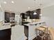 Well-appointed kitchen with granite countertops, dark cabinetry, and stainless steel appliances at 4624 Pebble Run Dr, Matthews, NC 28105