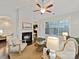 Cozy living room with fireplace, hardwood floors, neutral furniture, and large windows at 4624 Pebble Run Dr, Matthews, NC 28105
