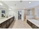 Elegant bathroom with granite counters, double sinks, glass shower, and soaking tub at 4624 Pebble Run Dr, Matthews, NC 28105